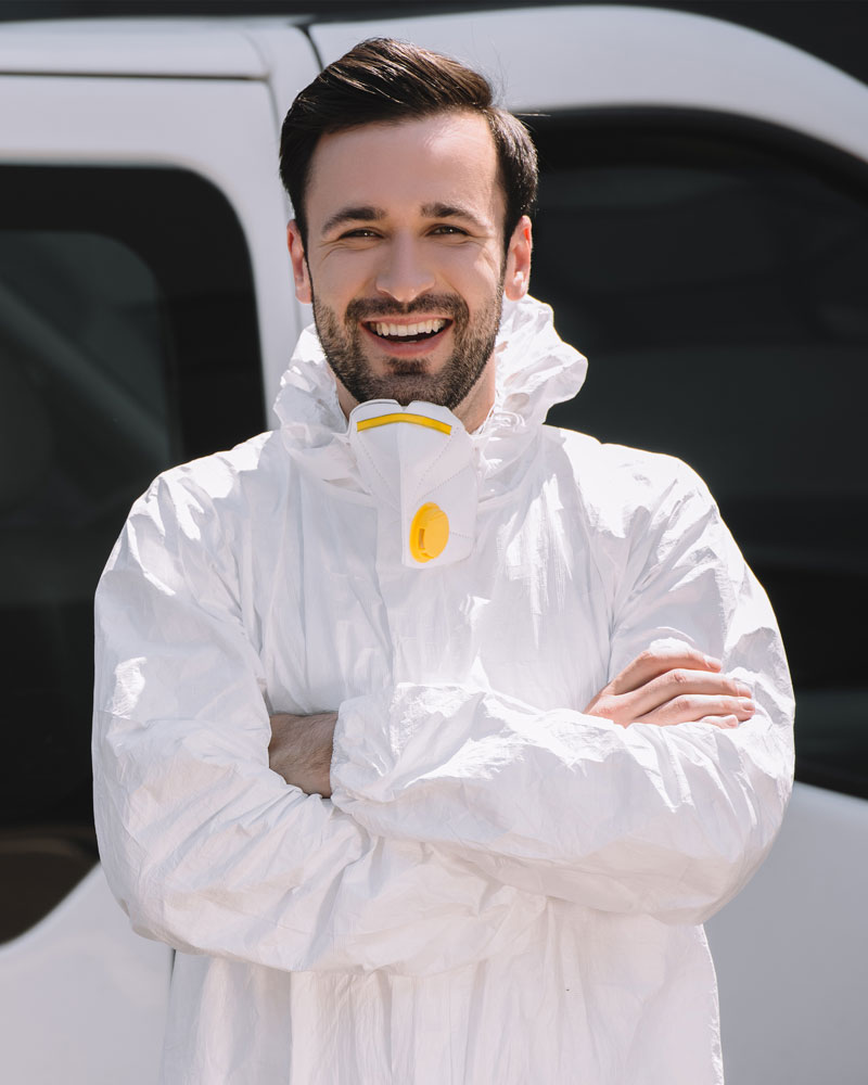 happy-pest-control-worker-in-uniform-standing-with.jpg